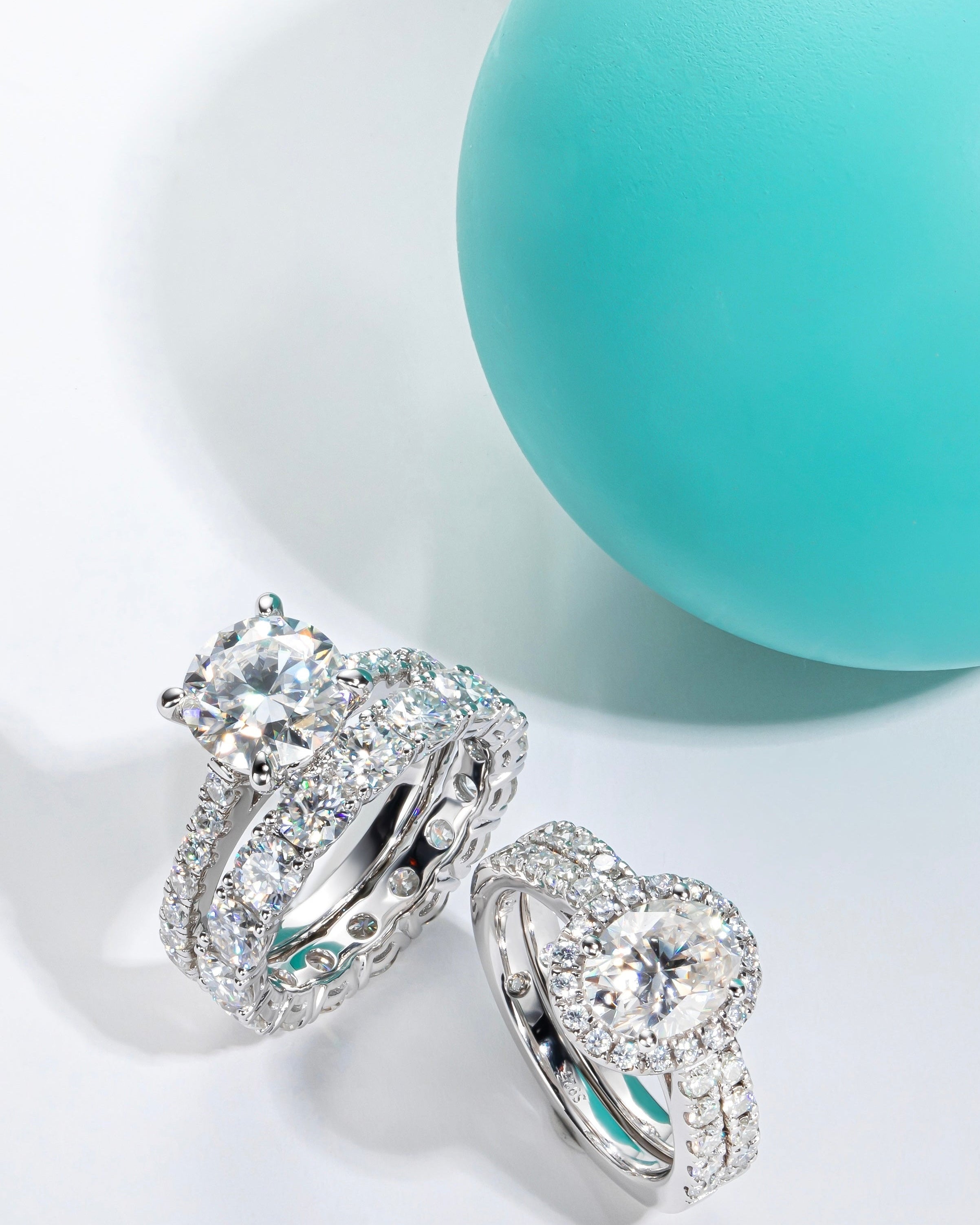 Silver earrings with gemstones on a light blue background